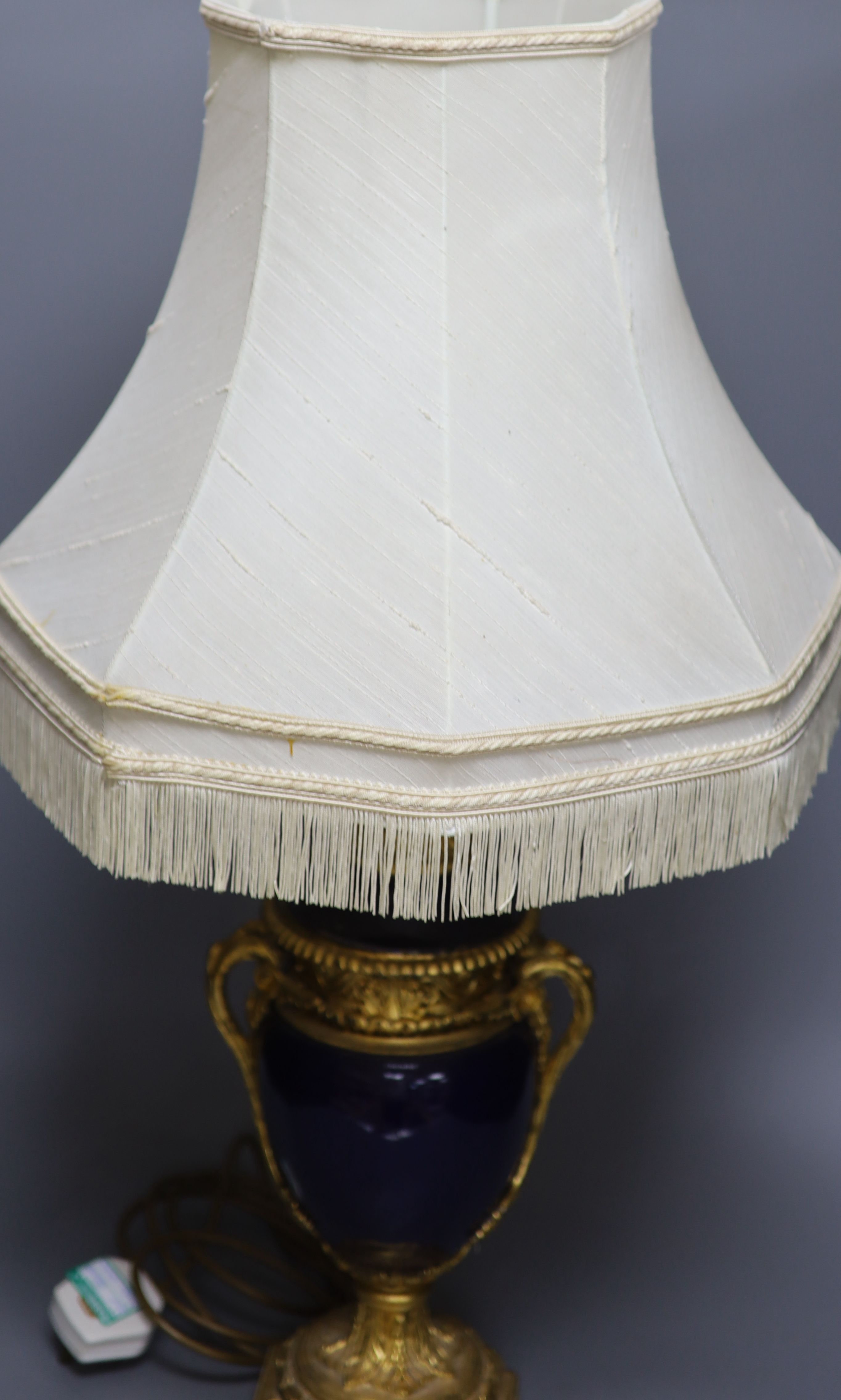 A French gilt metal and porcelain table lamp